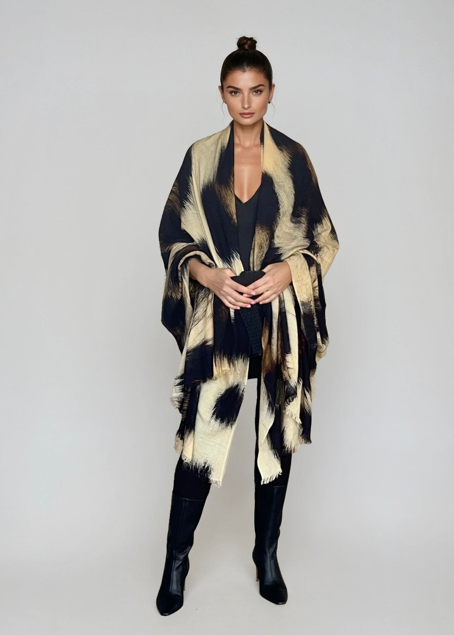 "Woman wearing cashmere wool wrap extra large with snow leopard print pattern showing luxury animal print design"