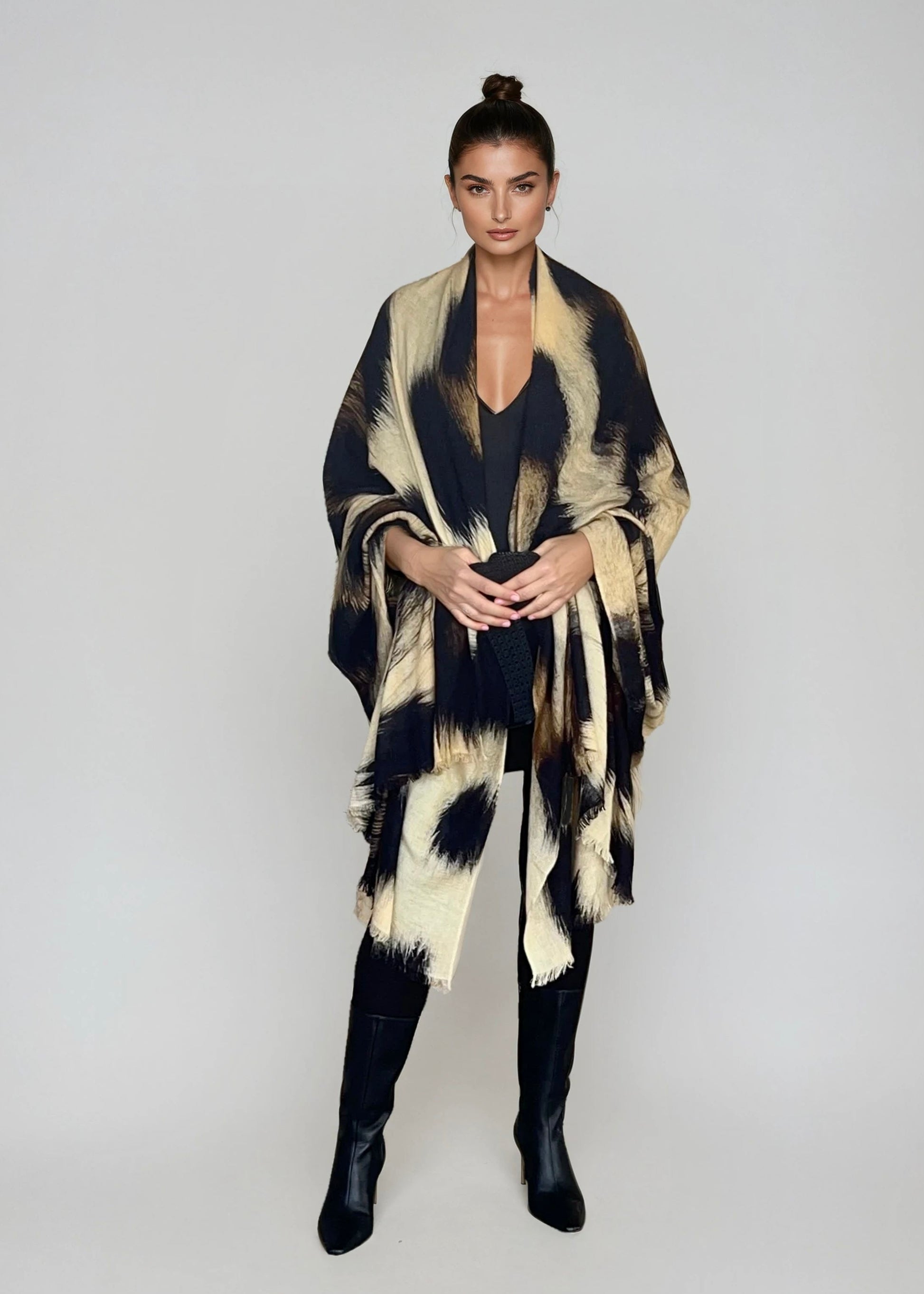 "Woman wearing cashmere wool wrap extra large with snow leopard print pattern showing luxury animal print design"