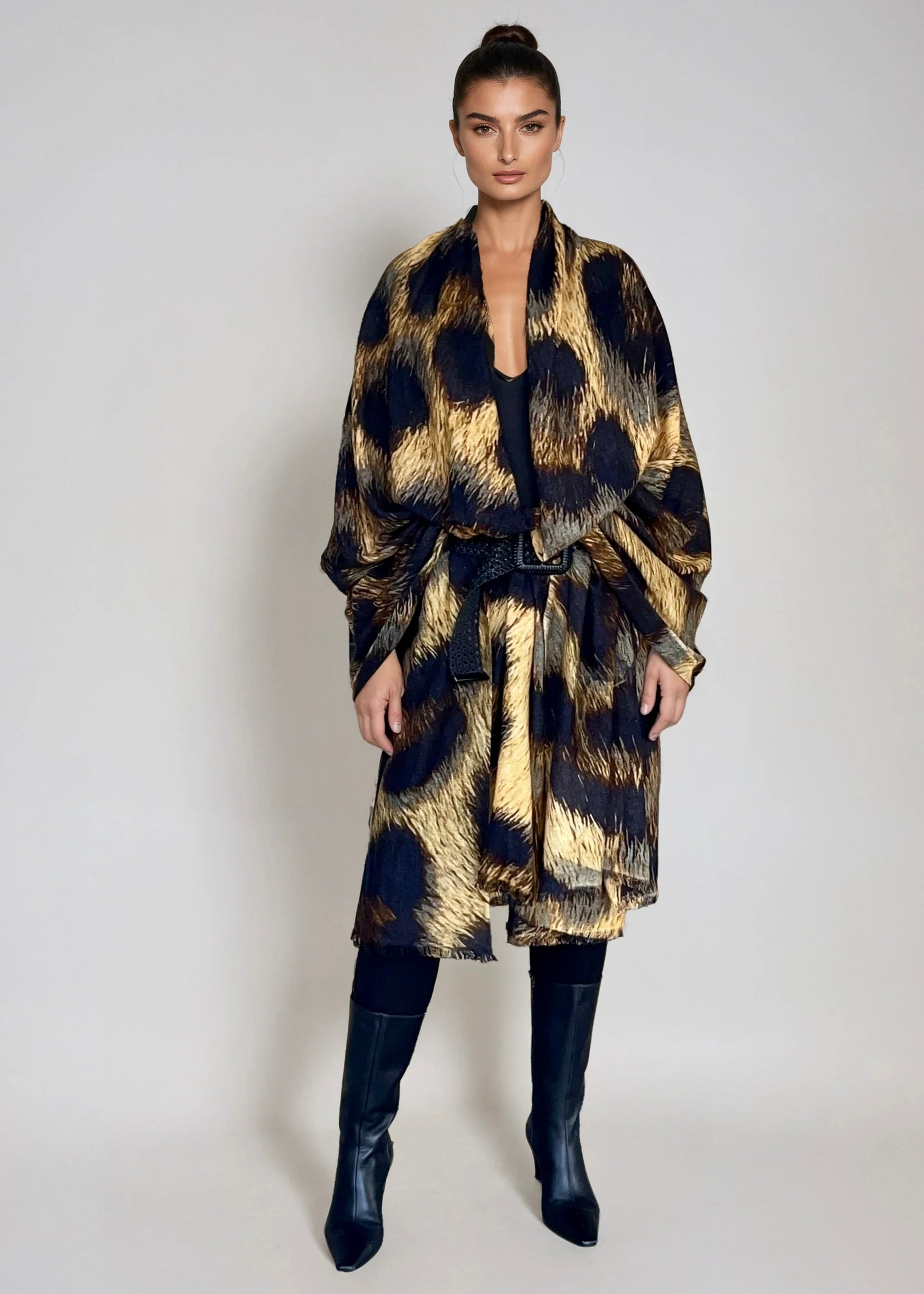 "Woman wearing extra large cashmere wool wrap with leopard print pattern showing luxury animal print design"