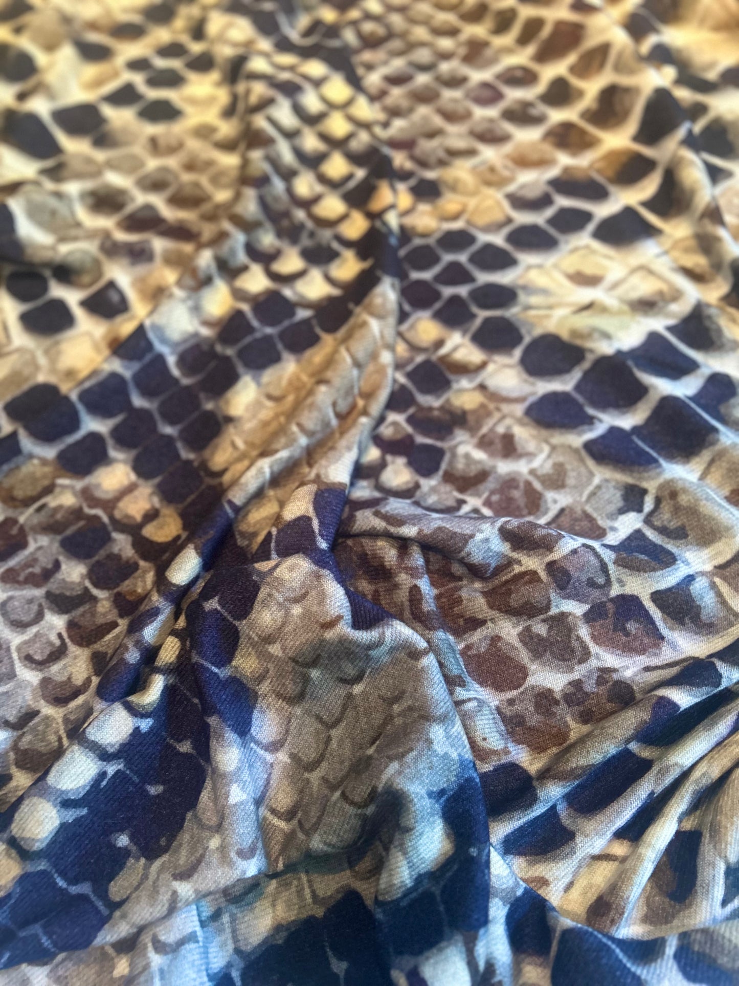 Close-up of fabric with snake skin pattern.