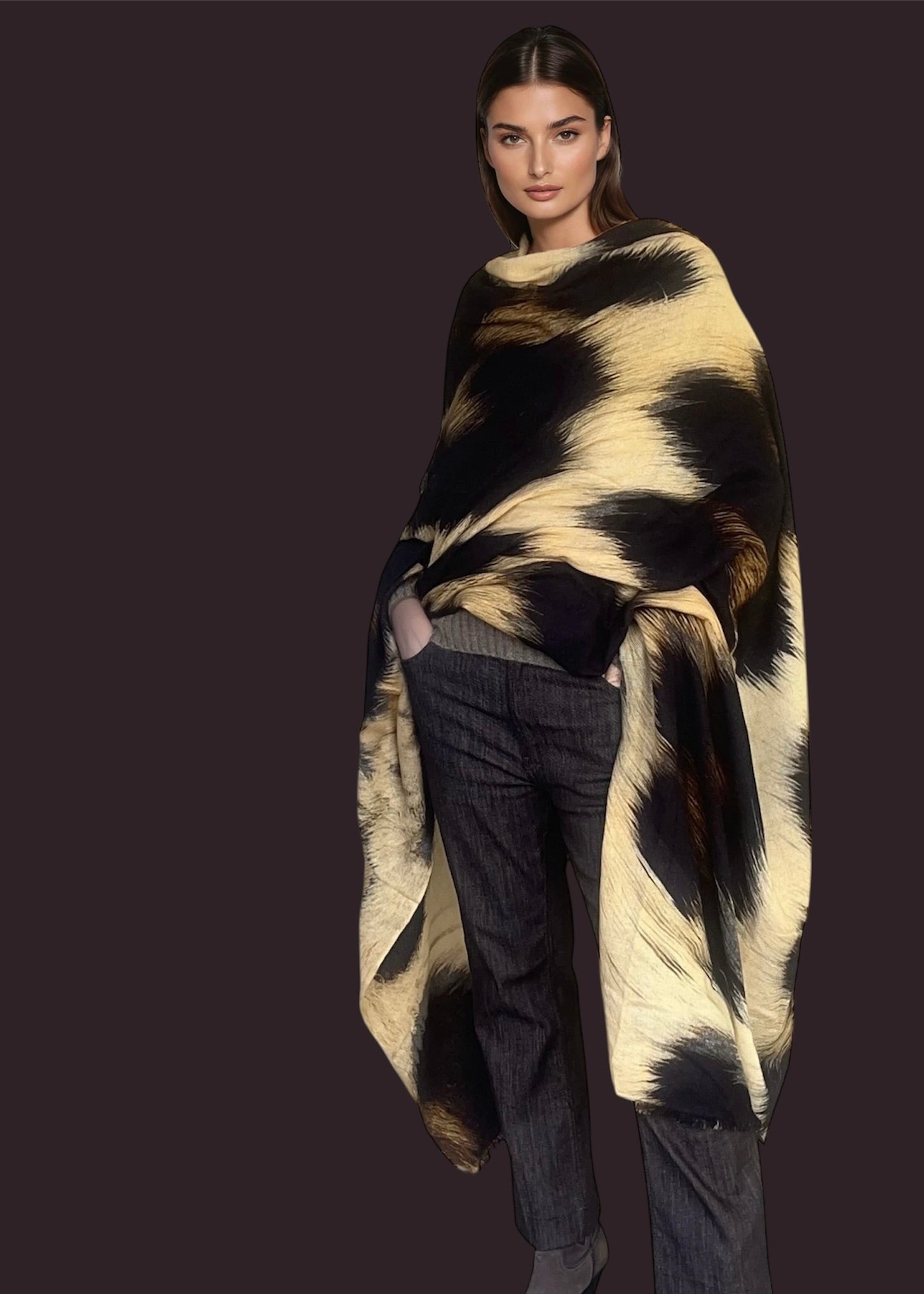 "Woman wearing  a extra large cashmere wool wrap with snow leopard print pattern showing luxury animal print design"