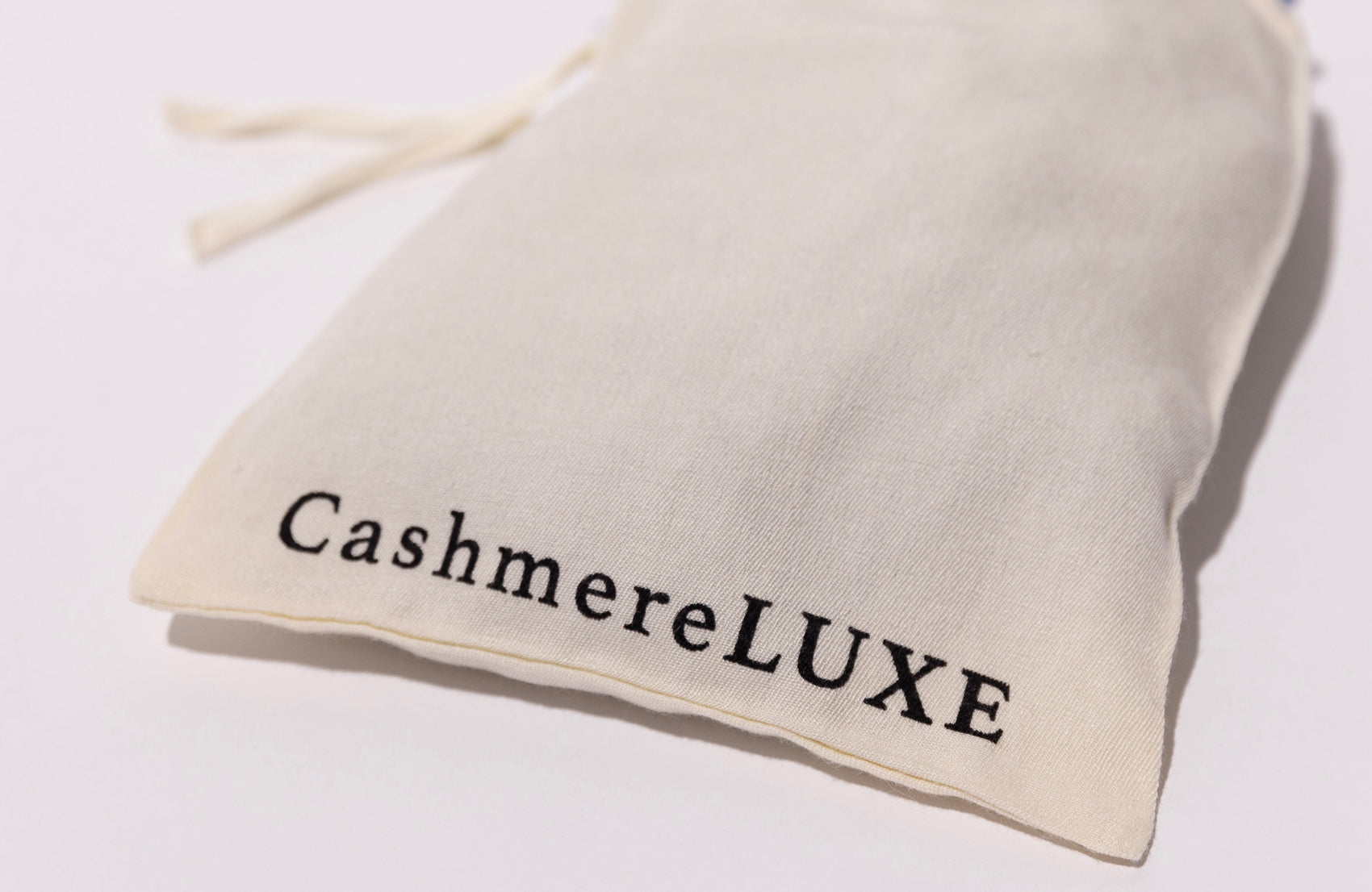 CashmereLUXE branded cashmere scarf on a white background