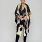 "Woman wearing cashmere wool wrap extra large with snow leopard print pattern showing luxury animal print design"