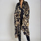 "Woman wearing cashmere wool, extra large wrap with snake print pattern showing luxury animal print design"