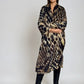 "Woman wearing cashmere wool, extra large wrap with snake print pattern showing luxury animal print design"
