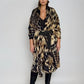 "Woman wearing cashmere wool, extra large wrap with snake print pattern showing luxury animal print design"