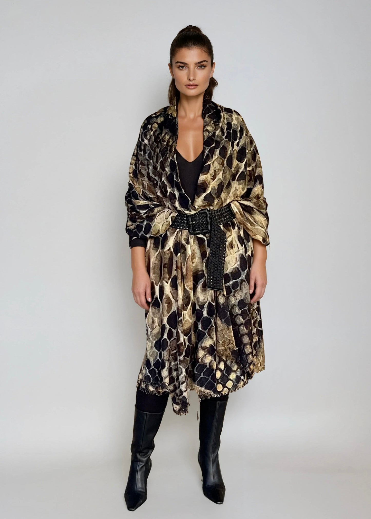 "Woman wearing cashmere wool, extra large wrap with snake print pattern showing luxury animal print design"