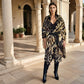 "Woman wearing cashmere wool, extra large wrap with snake print pattern showing luxury animal print design"