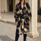 "Woman wearing cashmere wool extra large wrap with snake print pattern showing luxury animal print design"