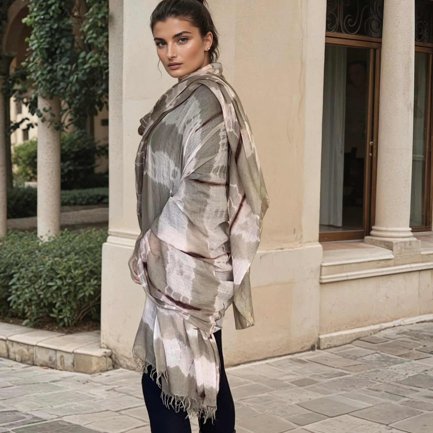 "Woman wearing limited edition hand tie-dyed extra large cashmere wrap in soft pink, taupe and brown showing unique color patterns"
