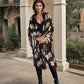 "Woman wearing limited edition hand tie-dyed, extra large cashmere wrap in earth brown ,white and a touch of forest green showing unique color patterns"