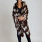 "Woman wearing limited edition hand tie-dyed cashmere wrap in earth brown ,white and a touch of forest green showing unique color patterns"