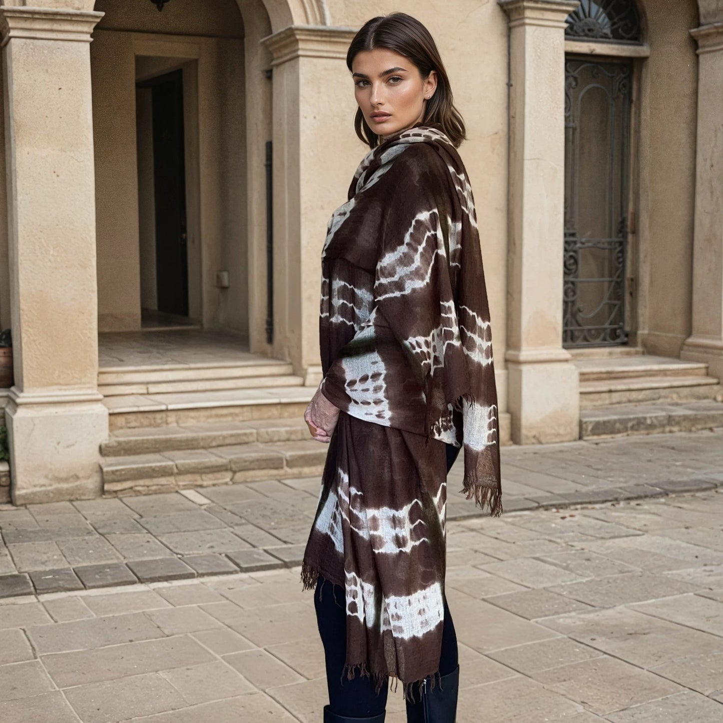 "Woman wearing limited edition hand tie-dyed, extra large cashmere wrap in earth brown ,white and a touch of forest green showing unique color patterns"