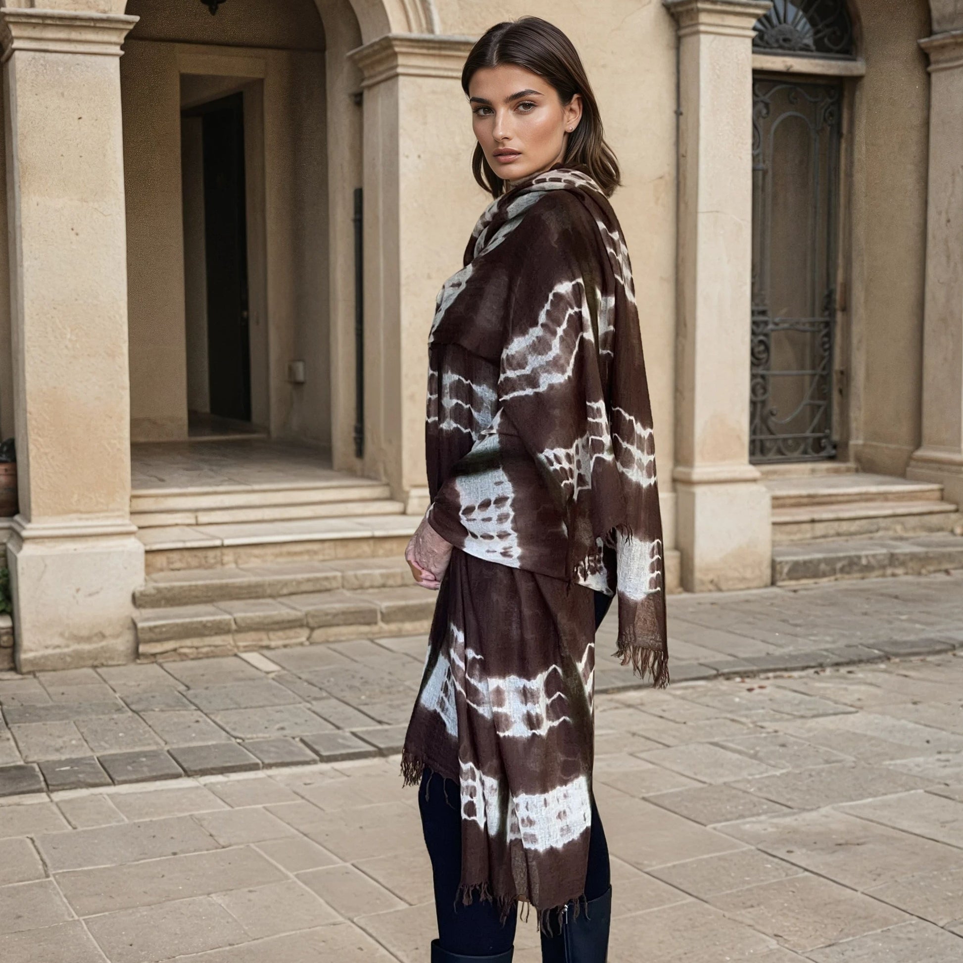 "Woman wearing limited edition hand tie-dyed, extra large cashmere wrap in earth brown ,white and a touch of forest green showing unique color patterns"