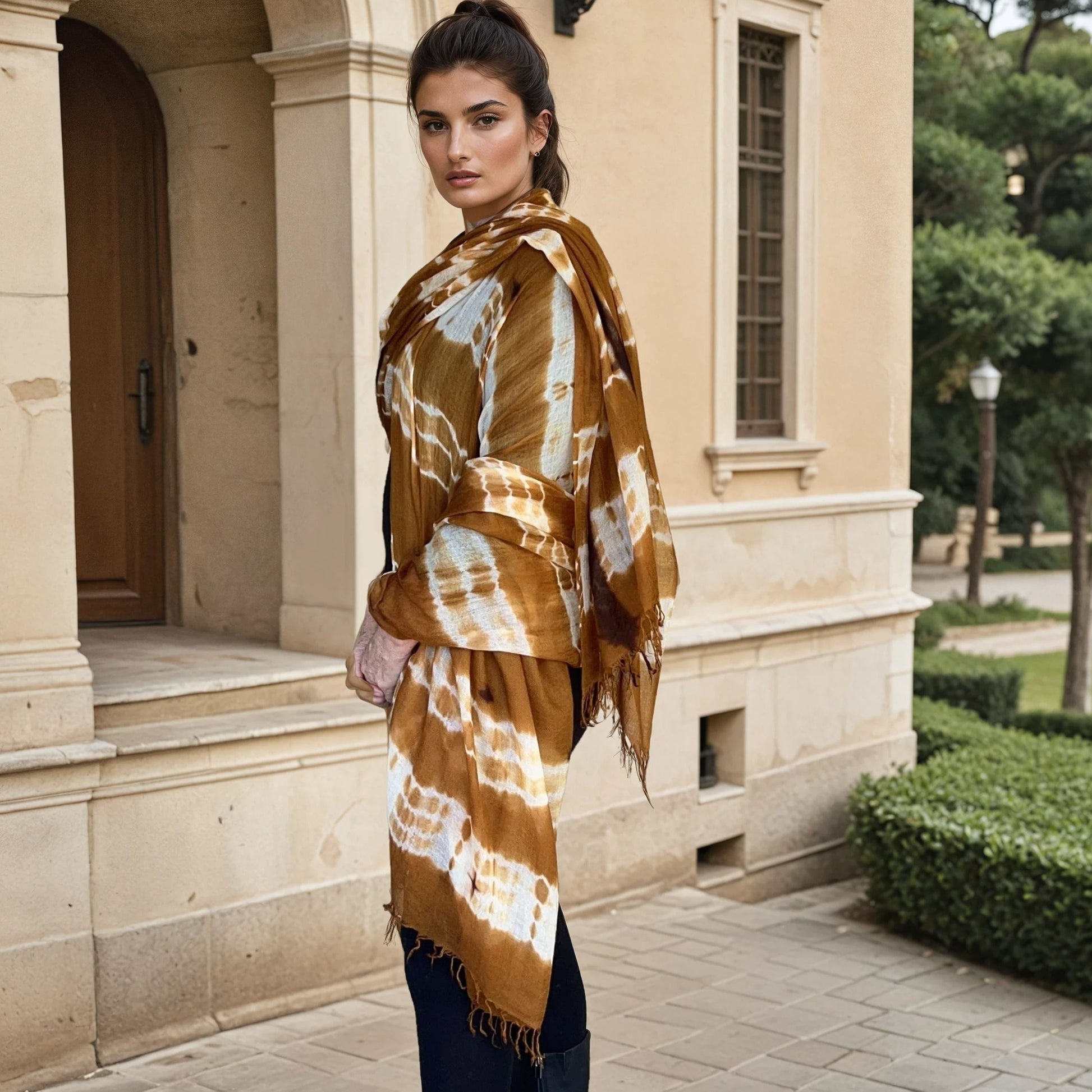 Image of woman wearing limited edition , extra large, hand tie-dyed cashmere shawl in bronze, white and brown showing unique color patterns"