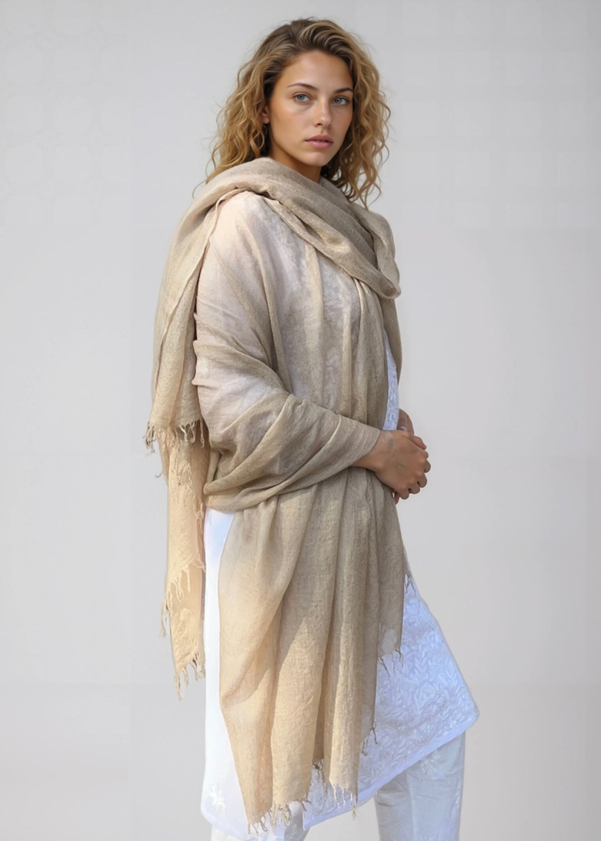 Oversized natural cashmere wrap draped over shoulders on model
