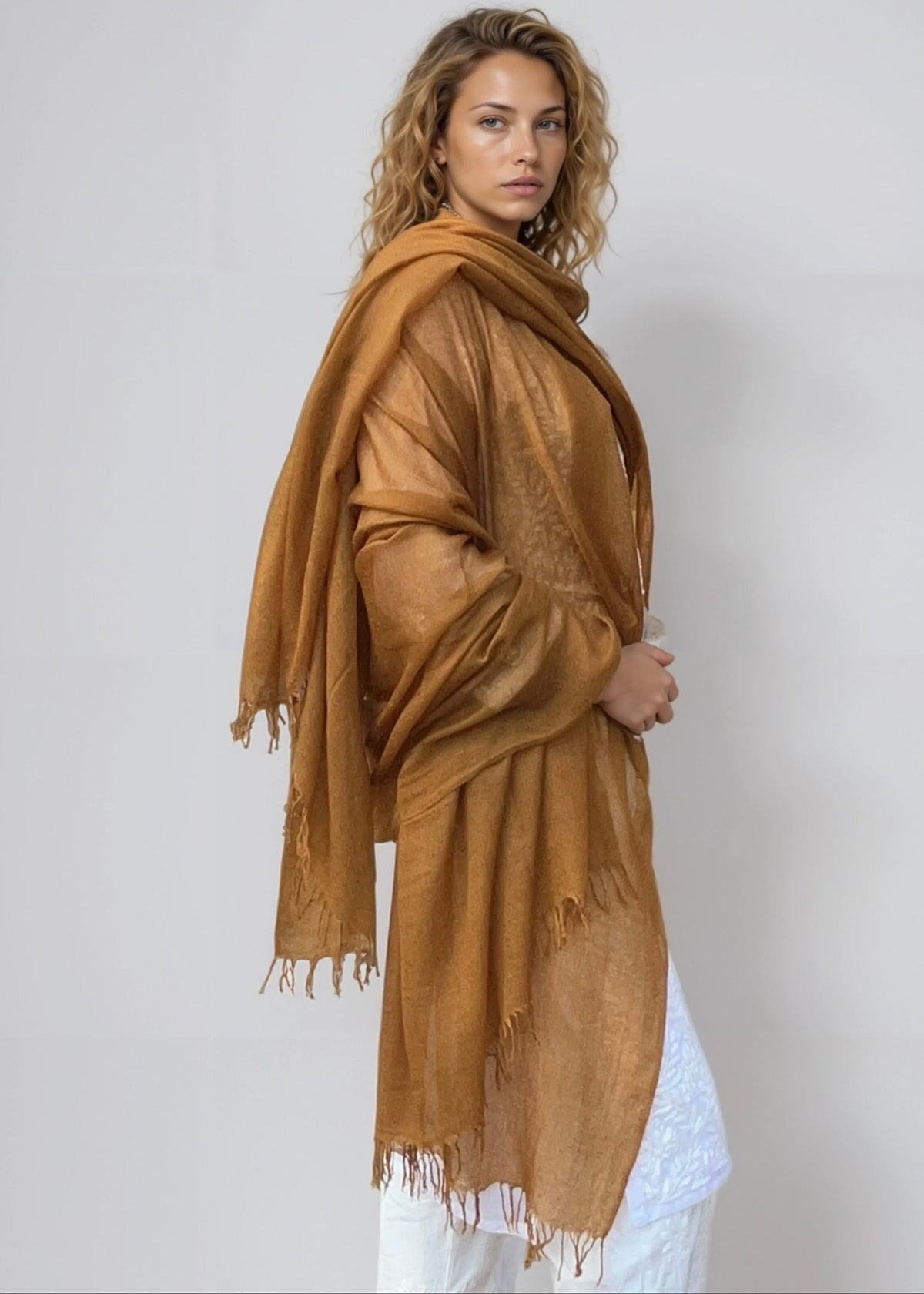 Burnt bronze cashmere wrap draped as oversized luxury shawl