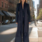 "Woman in city wearing black extra large cashmere shawl with tailored suit demonstrating luxury business styling"