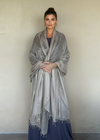 Taupe cashmere wrap draped as oversized luxury shawl