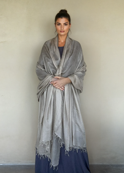 Taupe cashmere wrap draped as oversized luxury shawl