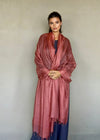 Model wearing burnt sienna cashmere wrap, handwoven Himalayan luxury