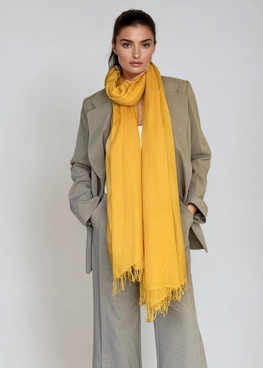Elegant saffron cashmere scarf styled for travel and everyday wear
