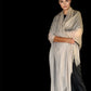 Woman wearing a beige scarf against a black background