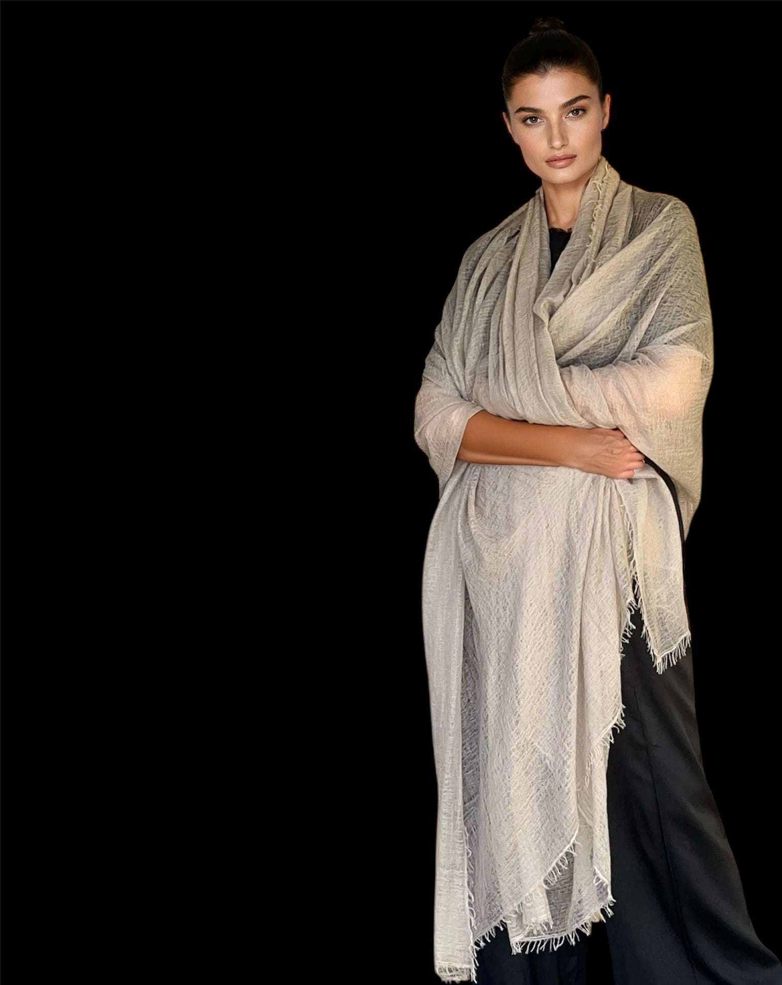 Woman wearing a beige scarf against a black background