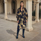 "Woman wearing extra large leopard print cashmere shawl showing luxury animal print styling"

