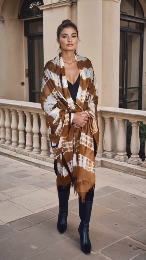 "Video of woman wearing limited edition hand tie-dyed cashmere wrap in bronze, white and brown showing unique color patterns"