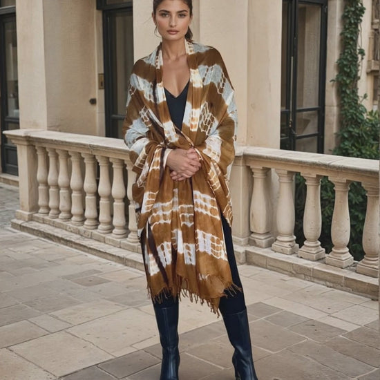 Image of woman wearing limited edition , extra large, hand tie-dyed cashmere wrap in bronze, white and brown showing unique color patterns"