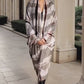 Video "Woman wearing limited edition hand tie-dyed extra large cashmere wrap in soft pink, taupe and brown showing unique color patterns"